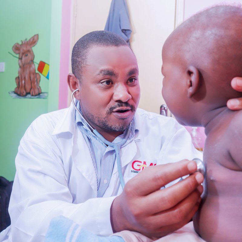 GMS Hospital clinician carefully examining a child